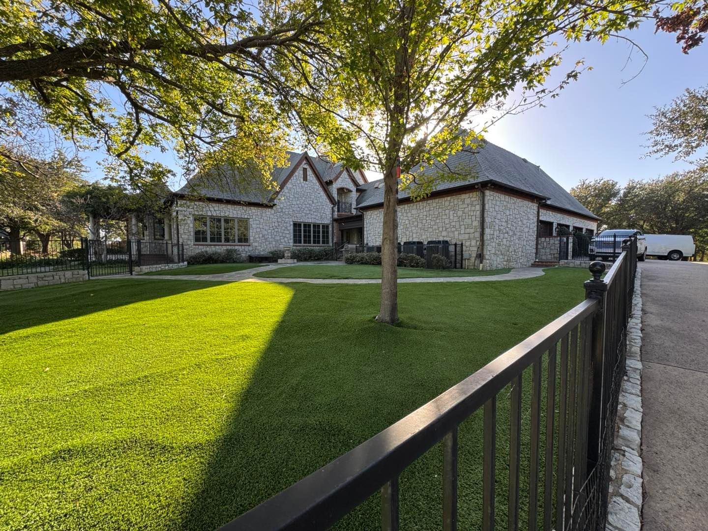 A large house with a fence in front of it