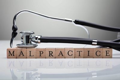Stethoscope Over Malpractice Wooden Block — King Of Prussia, PA — McGilvery & Juliana