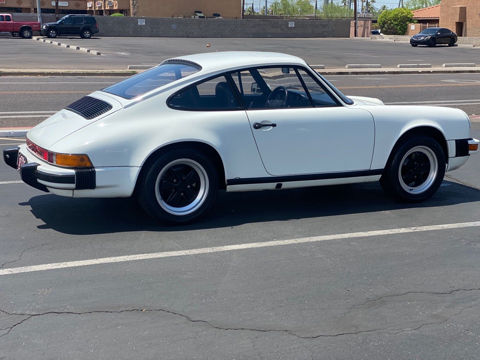 White Porsche 911 parked on asphalt | Import Car Specialists