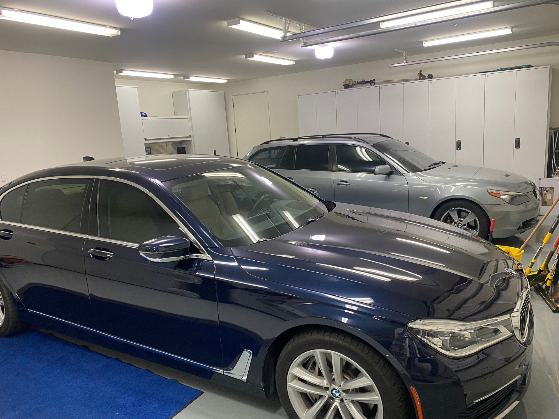 Two BMW cars parked in a well-lit garage | Import Car Specialists