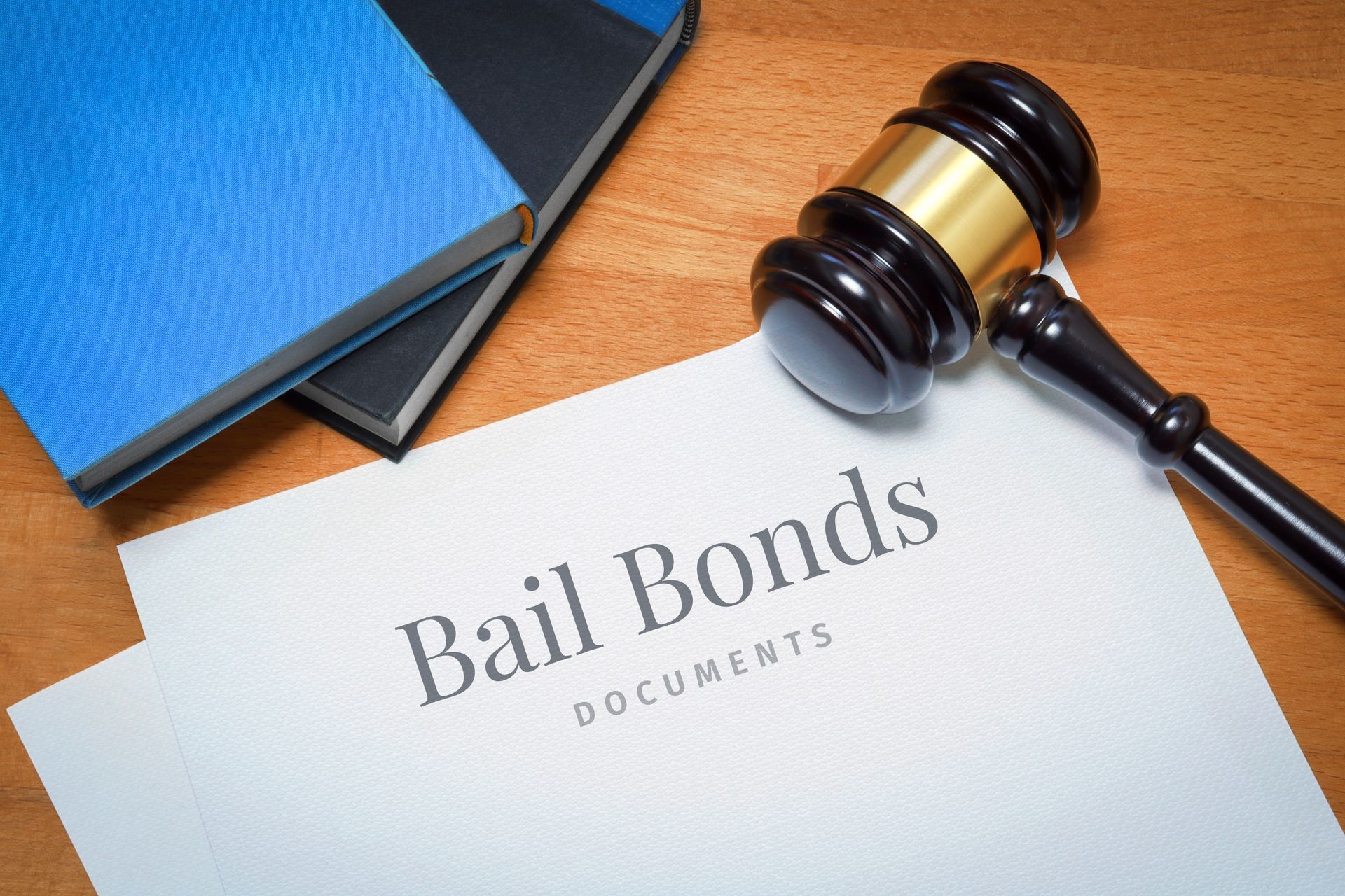 Bail bonds documents beside a gavel on a wooden desk