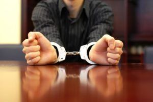Man Showing Handcuffs — St. Minneapolis, MN — Absolute Bail Bonds