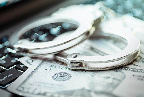 Handcuffs On Top Of Cash — St. Minneapolis, MN — Absolute Bail Bonds