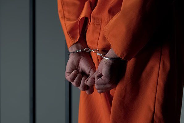 Man On Orange Uniform — St. Minneapolis, MN — Absolute Bail Bonds