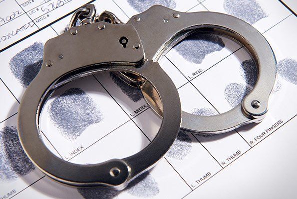 Handcuffs & Paper With Fingerprints — St. Minneapolis, MN — Absolute Bail Bonds