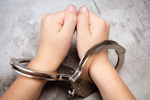Hands Wearing Handcuffs — St. Minneapolis, MN — Absolute Bail Bonds