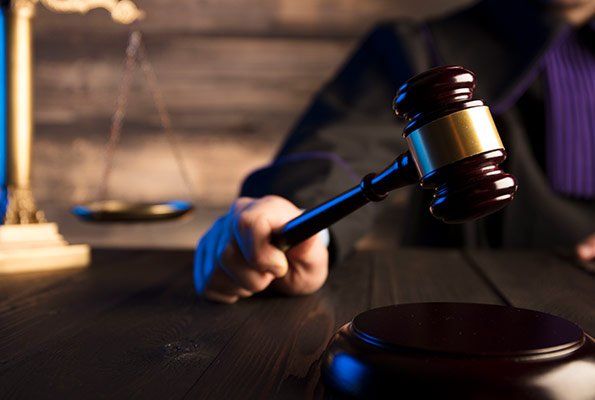 Judge Holding Wooden Gavel — St. Minneapolis, MN — Absolute Bail Bonds