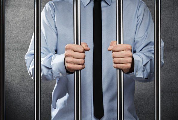 Man Wearing Tie Inside Cell Bar — St. Minneapolis, MN — Absolute Bail Bonds