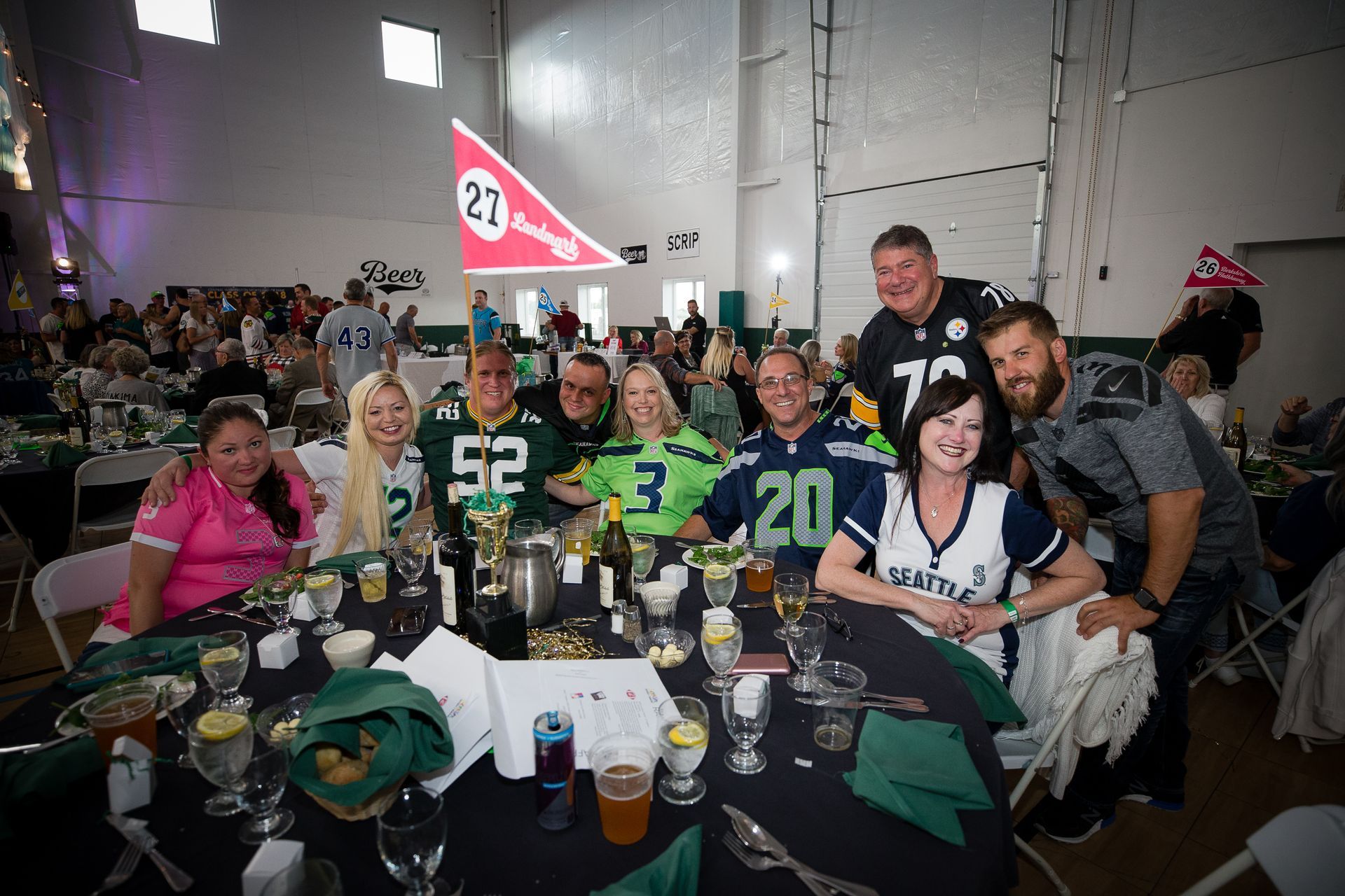 A group of people are posing for a picture at a table.