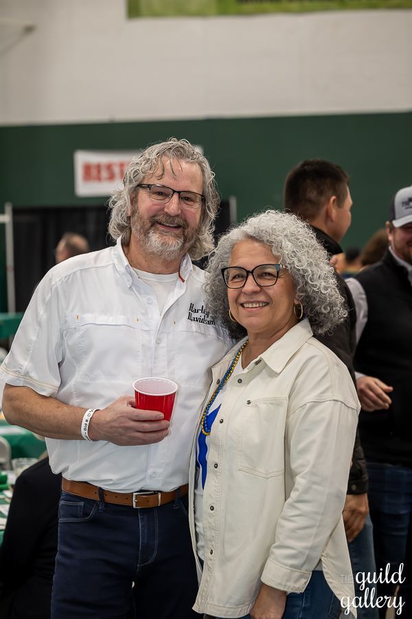 A man and a woman are posing for a picture at a party.