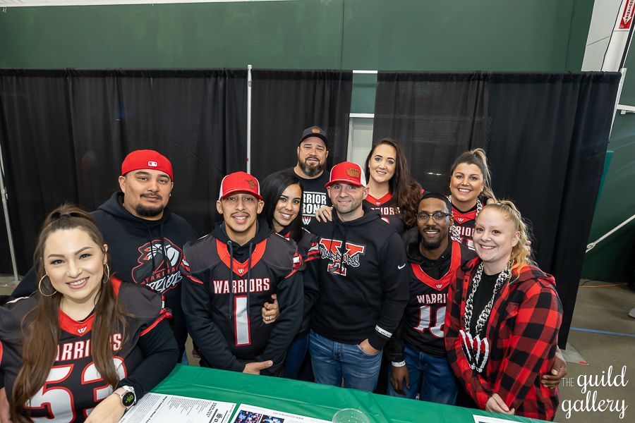 A group of people are posing for a picture in a room.
