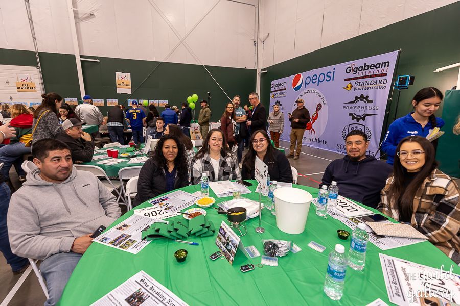 A group of people are sitting at a table in a room.