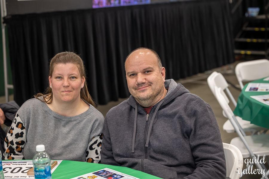 A man and a woman are sitting at a table.