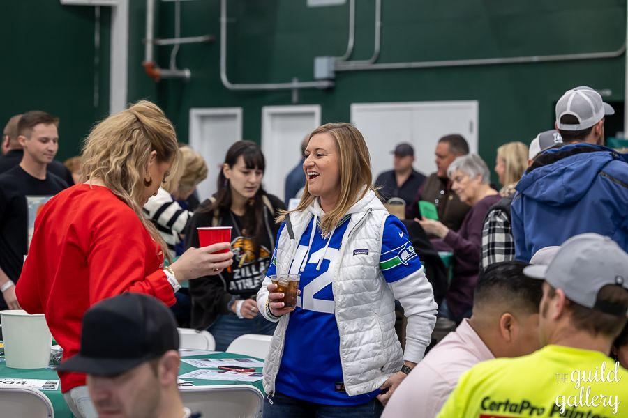 A group of people are sitting at tables in a room.