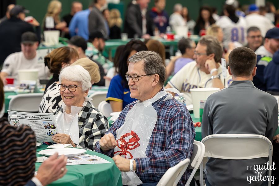 A group of people are sitting at tables in a room.