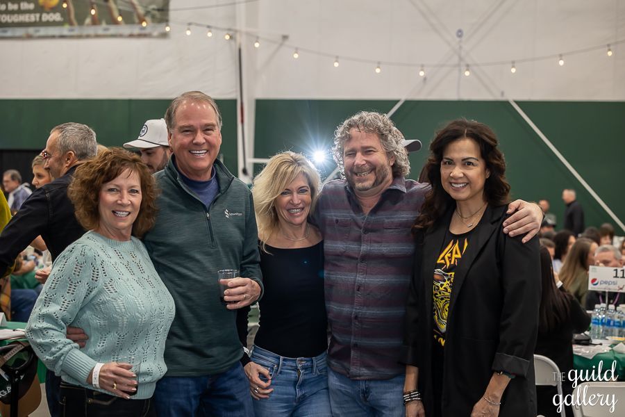 A group of people are posing for a picture at a party.