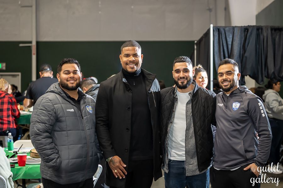 A group of men are posing for a picture together in a room.