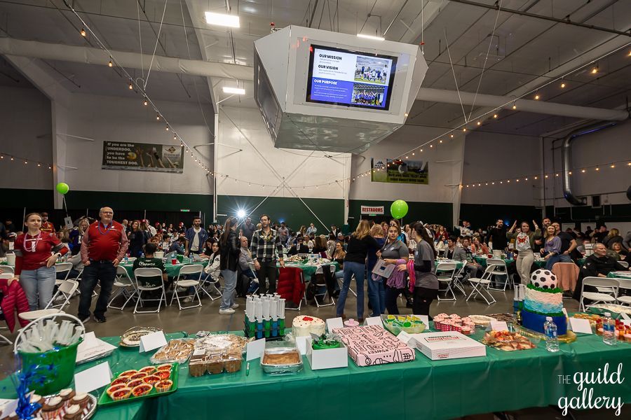 A large group of people are sitting at tables in a large room.