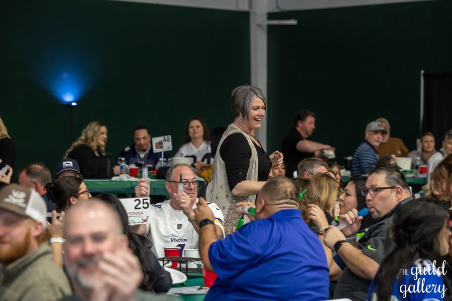 A group of people are sitting at tables in a room.