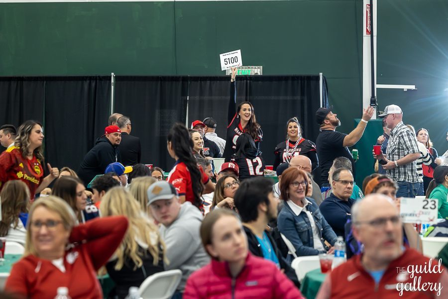 A large group of people are sitting at tables in a room.