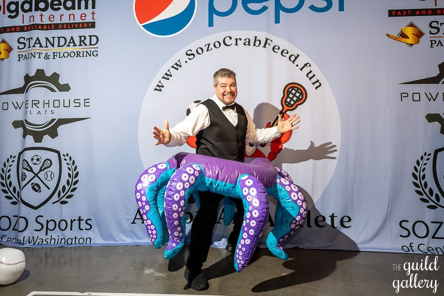 A man is standing in front of a pepsi banner