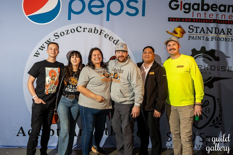 A group of people standing in front of a pepsi sign