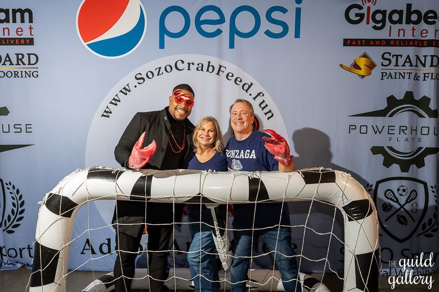 A group of people standing in front of a pepsi sign
