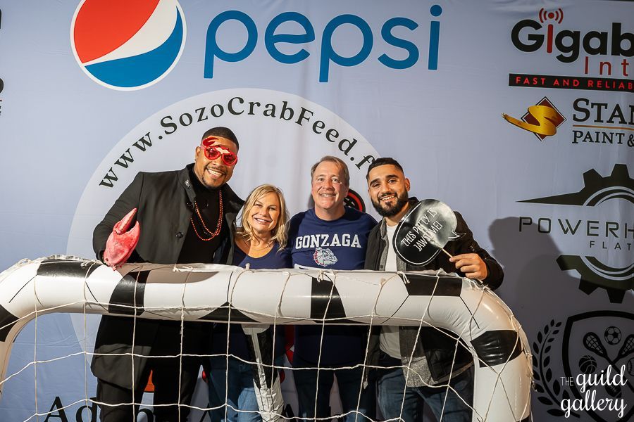 A group of people standing in front of a pepsi sign
