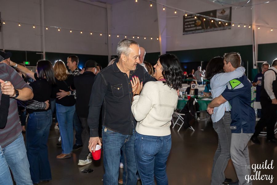 A group of people are dancing in a room at a party.