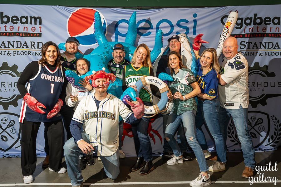 A group of people are posing for a picture in front of a pepsi banner.