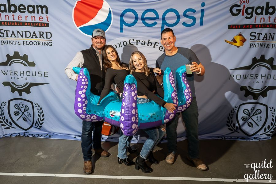 A group of people standing in front of a pepsi banner