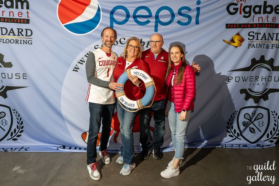 A group of people standing in front of a pepsi banner