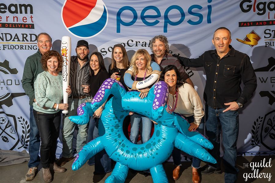 A group of people standing in front of a pepsi banner