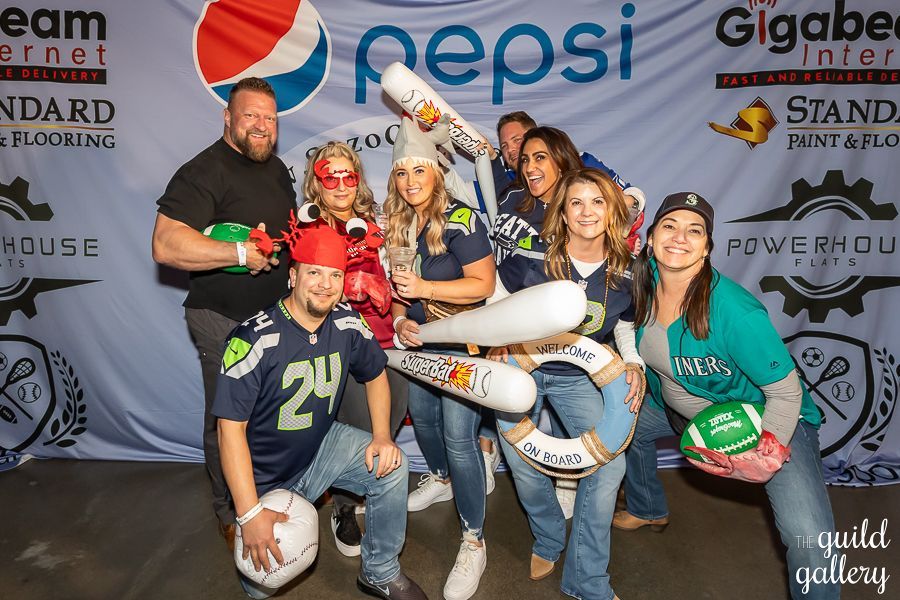 A group of people standing in front of a pepsi banner