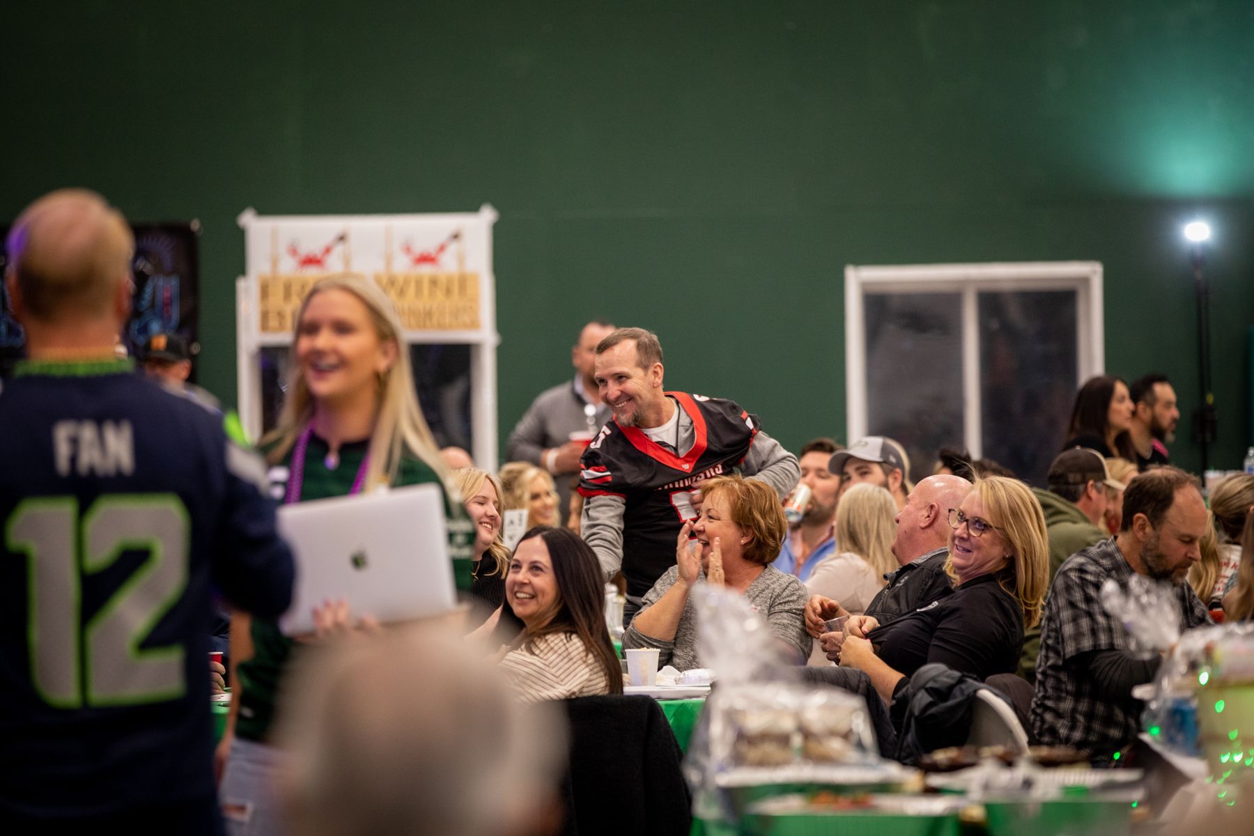 A group of people are sitting at tables in a room.
