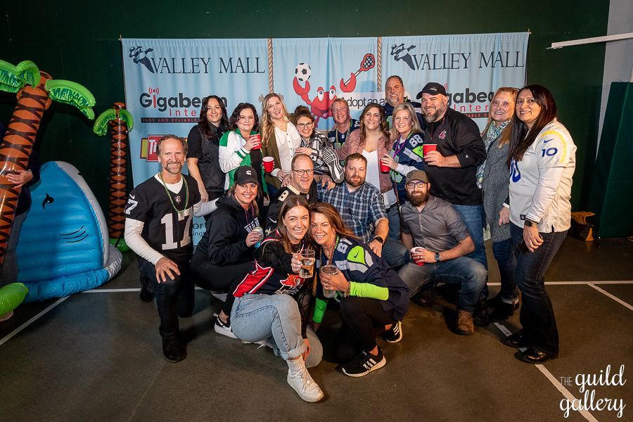 A group of people are posing for a picture in front of a banner.