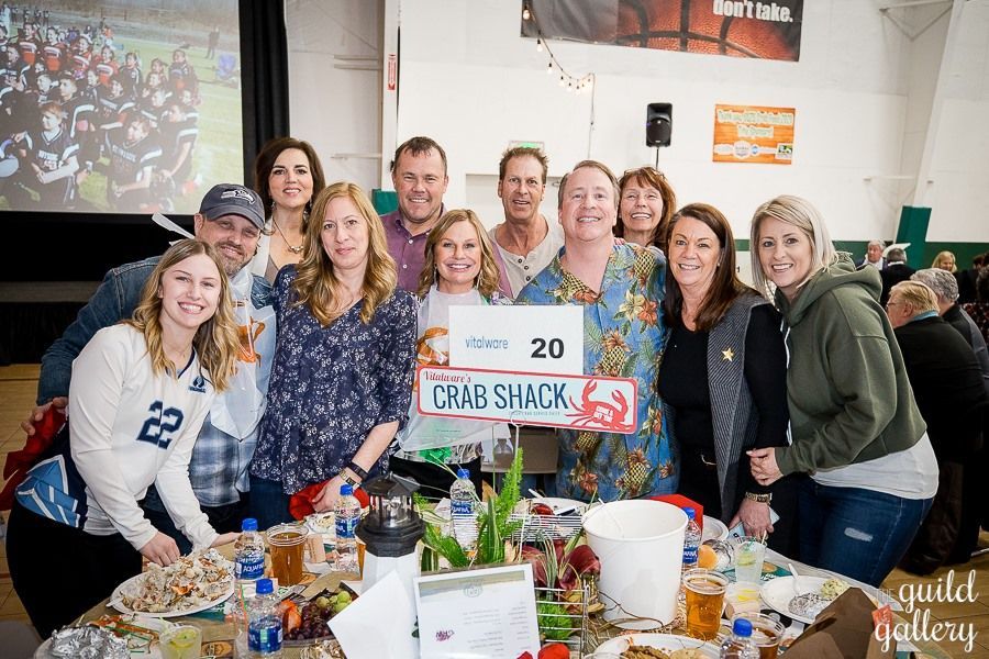 A group of people are posing for a picture at a crab shack.