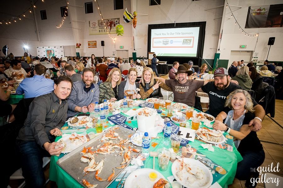 A group of people are sitting at a table with plates of food.