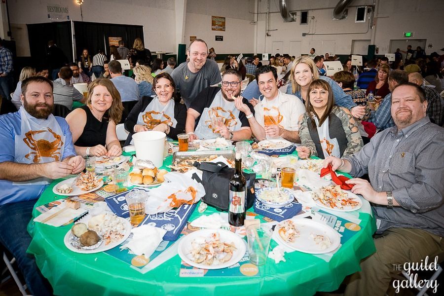 A group of people are sitting at a table with plates of food.