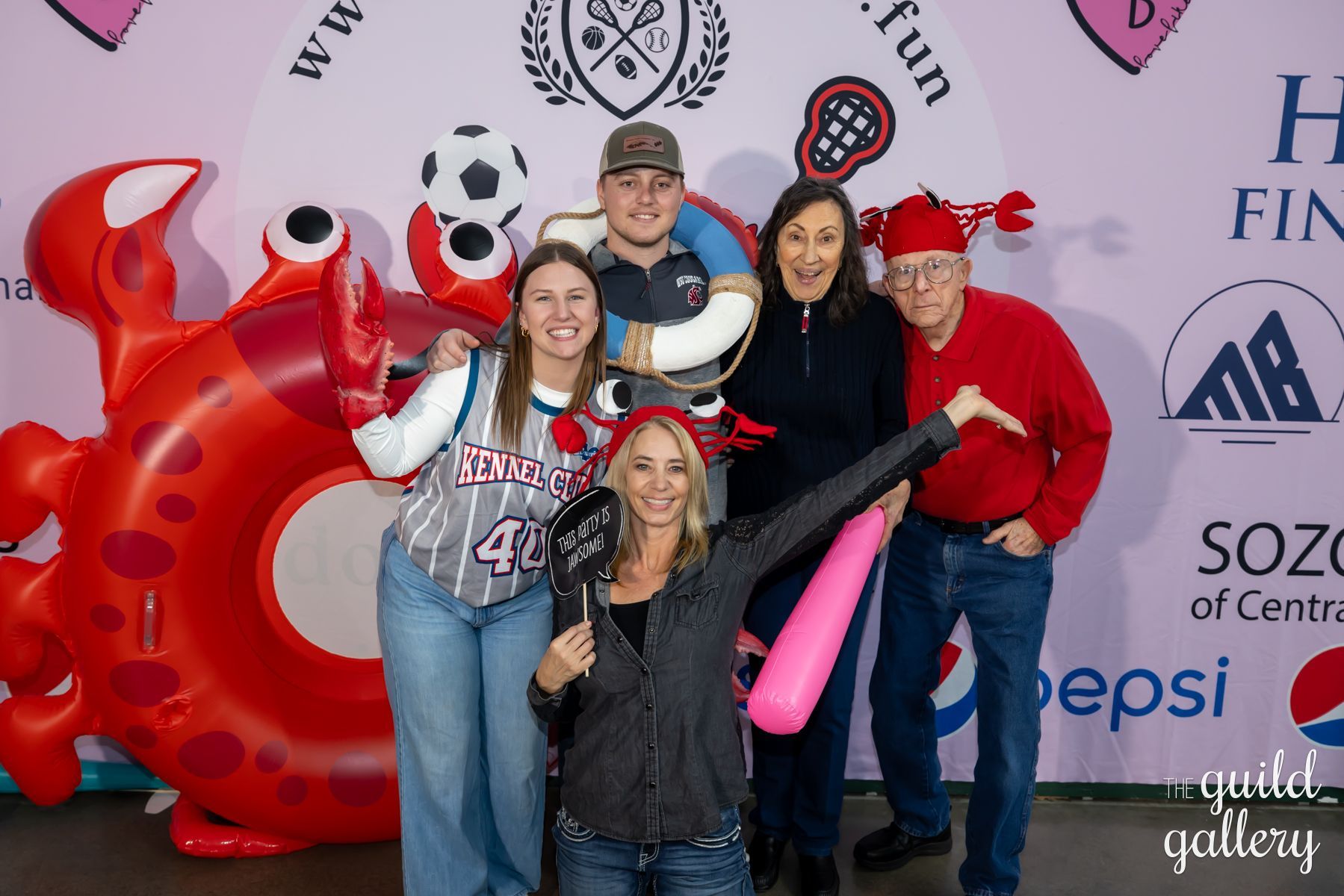 A group of people are posing for a picture in front of an inflatable crab.