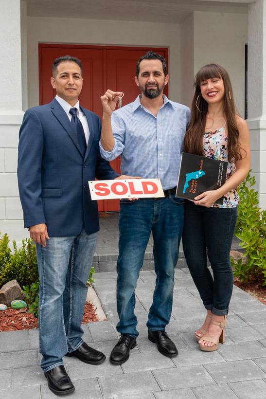 Agent standing with Home Buyers