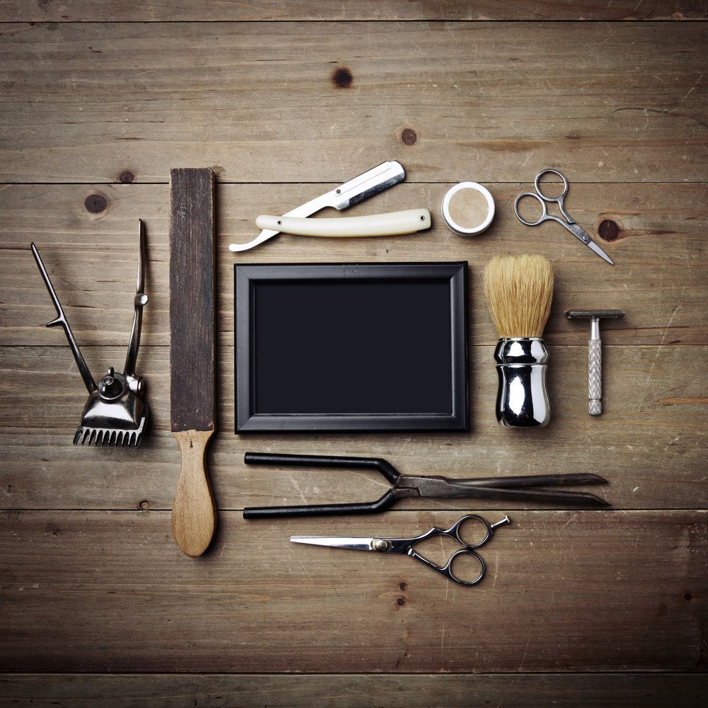 A Wooden Table Topped With Barber Tools — Bermann Barbershop In Casey, ACT