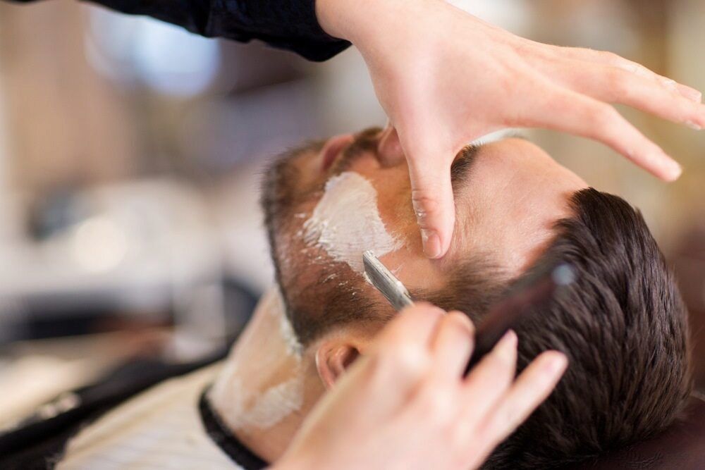 Barber Shaving a Man's Face With a Straight Razor and Shaving Cream — Bermann Barbershop in Casey, ACT