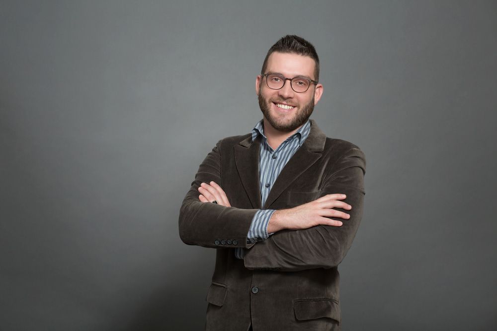 Man With Glasses, Arms Crossed and Smiling