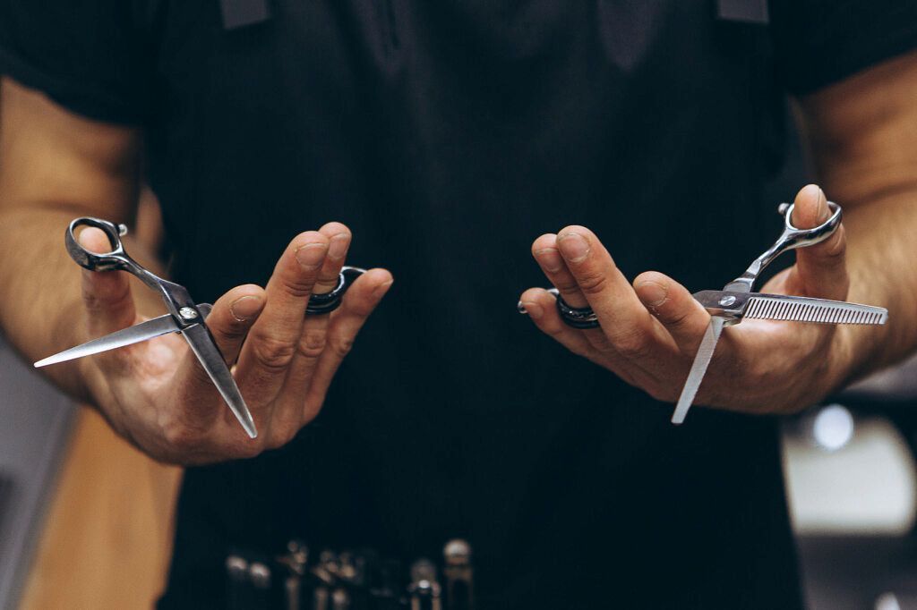 Hands Holding Open Scissors, a Barber Ready to Cut Hair — Bermann Barbershop in Gungahlin, ACT