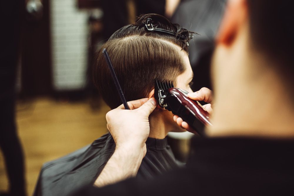 Barber Cutting a Client's Hair With Clippers — Bermann Barbershop in Ngunnawal, ACT