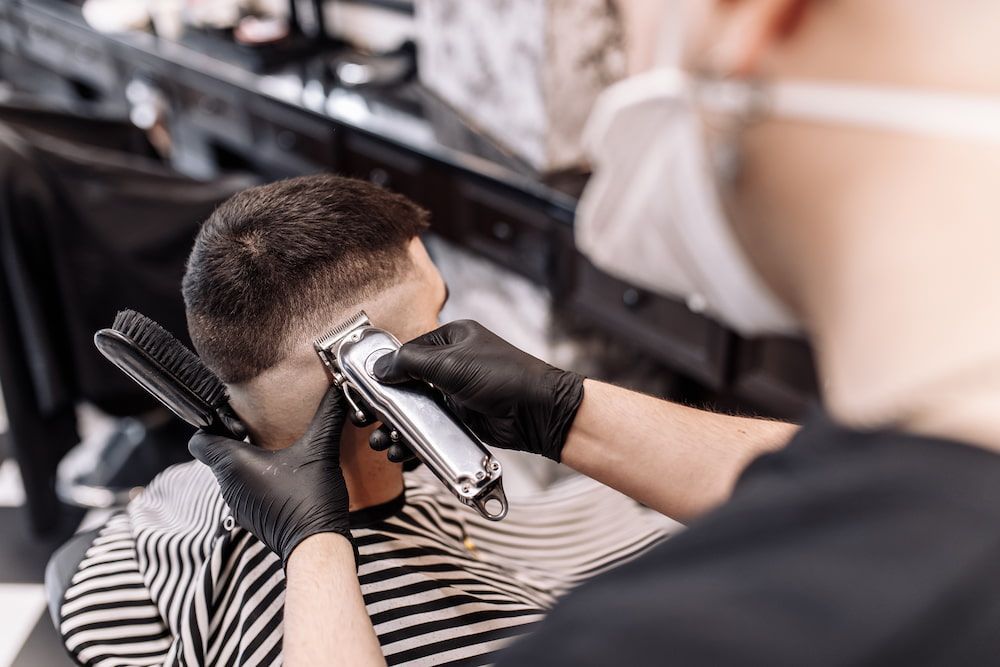 Barber Using Clippers on a Client's Hair — Bermann Barbershop in Gungahlin, ACT