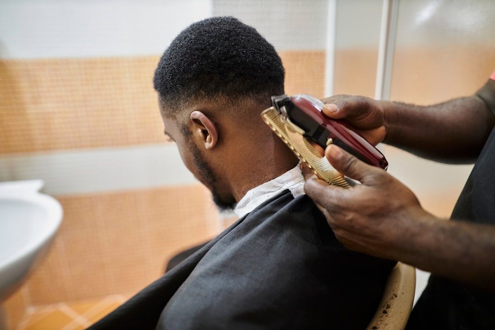 Barber Giving a Black Man a Fade Haircut — Bermann Barbershop in Gungahlin, ACT