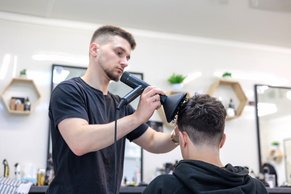 Barber Using a Hair Dryer With Diffuser on a Client — Bermann Barbershop in Ngunnawal, ACT