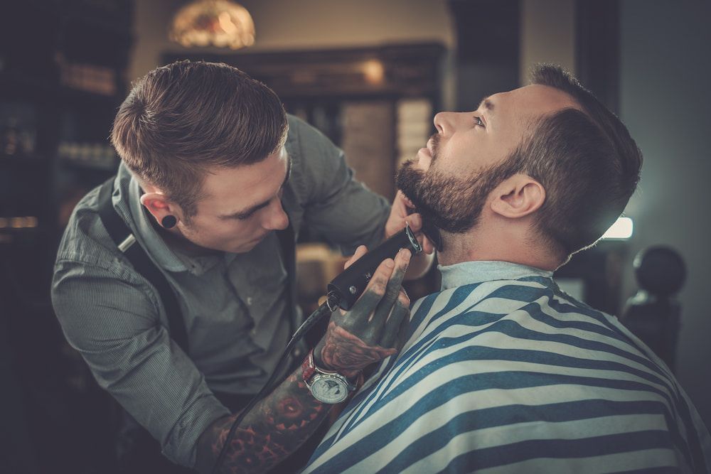 Barber Trimming a Man's Beard in a Barbershop — Bermann Barbershop in Nicholls, ACT